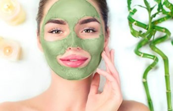 Young woman with herbal face mask